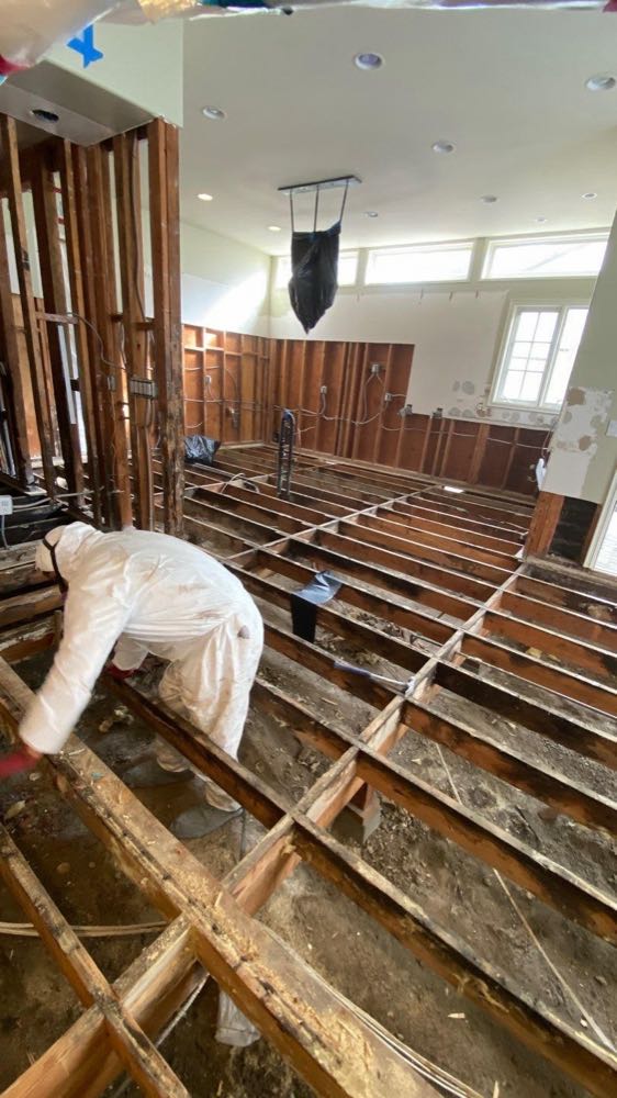 Water-damaged room with flooring and lower walls removed during mitigation